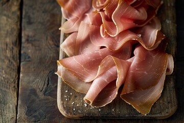 Canvas Print - Thinly sliced ham arranged on a rustic wooden cutting board