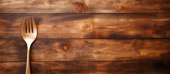Fototapete - Copy space image of a wooden background adorned with a spoon and fork