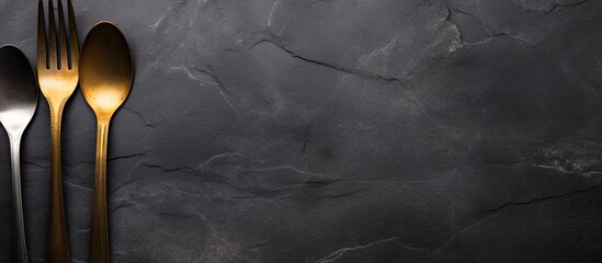 Aufkleber - Top view of a set of salad cutlery on a dark background made of slate stone or concrete with ample space for additional images or text