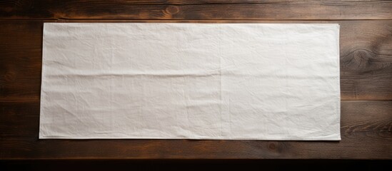 Leinwandbilder - An old table showcasing a white paper napkin featuring a textured pattern creating a visually interesting and intricate copy space image