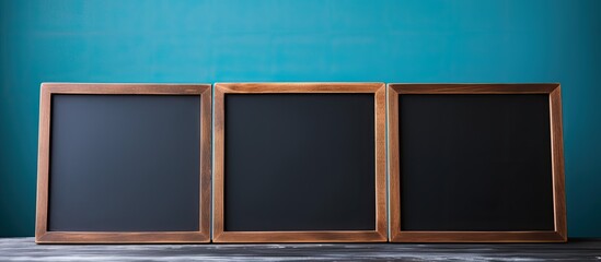 Aufkleber - A copy space image showing a hand holding a blank mini blackboard against a blue background perfect for adding text