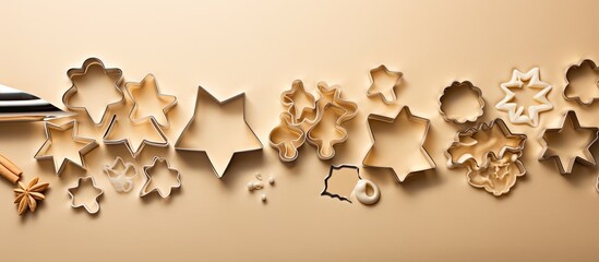 Poster - Christmas cookies and cutters arranged on a beige background with ample copy space for text or graphic elements in the image