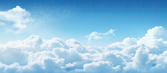 Fototapete - A photo displaying a sunny blue sky filled with fluffy white clouds and ample space for inserting text or images