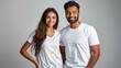 © Umme - Young Indian couple in white t-shirt, mockup, man woman smiling together in studio, copy space