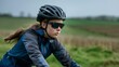 © LukaszDesign - Happy woman, cyclist, and triathlete pondering in nature. Motivation, cardio performance independence, female rider, cycle helmet and glasses for workout gear.