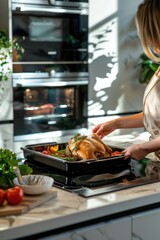 Wall Mural - the woman takes the chicken out of the oven. selective focus