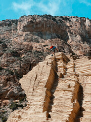 Sticker - Vertical of a person hiking down a steep sand path at Beach Atlantis, Ibiza, Spain