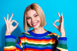 © deagreez - Portrait of pretty young girl show okey symbol wear striped pullover isolated on blue color background