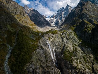 Wall Mural - Breathtaking view of the Kazbegi region in Georgia, with its stunning glacier and waterfall