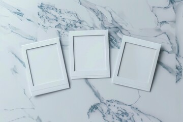 Poster - Three empty white picture frames on a marble surface. Perfect for interior design concepts