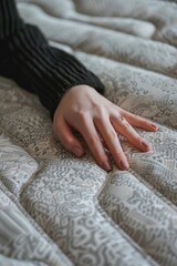 Aufkleber - A woman's hand resting on a mattress. Suitable for home decor or sleep-related concepts