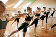 © standret - Active training. Group of female kids practicing athletic exercises together indoors
