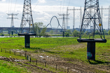 Two high voltage pylons made of steel, placed on concrete stilts for flood protections in the floodplains of the river Waal near Nijmegen, The Netherlands