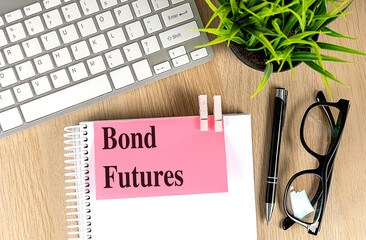 Poster - BOND FUTURES text pink sticky on notebook with keyboard, pen and glasses