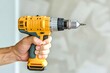 © Karen - Hand Holding Yellow Cordless Power Drill