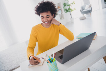 Canvas Print - Photo of nice funny cheerful man sitting table working writing homework white light interior room indoors