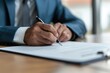 © Olena - Agreement Pen. Businessman Signing Corporate Contract in Modern Office Setting