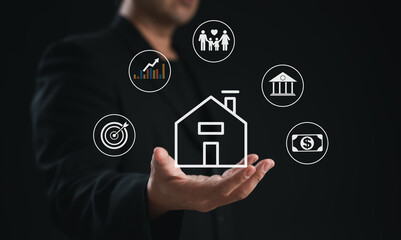 A person in a suit holds a house icon surrounded by financial and family symbols, representing real estate and investment concepts.
