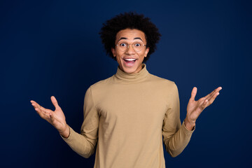 Sticker - Photo portrait of attractive young man excited raise hands dressed stylish beige clothes isolated on dark blue color background