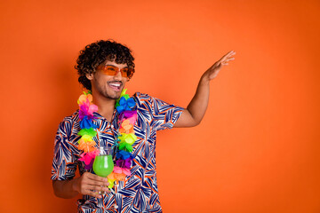 Sticker - Photo of attractive young man dancing hold cocktail enjoy summer dressed stylish colorful clothes isolated on orange color background