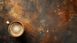 © Imane - top view of an aged brown coffee cup on a rustic dark-toned surface
