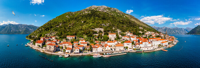 Wall Mural - View of the historic town of Perast at famous Bay of Kotor on a beautiful sunny day with blue sky and clouds in summer, Montenegro. Historic city of Perast at Bay of Kotor in summer, Montenegro.
