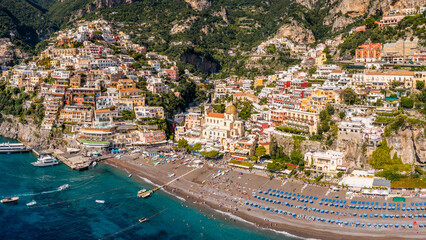 Wall Mural - Aerial view of Positano with comfortable beach and blue sea on Amalfi Coast in Campania, Italy. Positano village on the Amalfi Coast, Salerno, Campania. Beautiful Positano, Amalfi Coast in Campania.