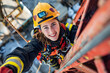 © AI_images_for_people - A woman firefighter participating in a high-angle rescue operation, her agility and fearlessness essential as she ascends a towering structure to reach and rescue a stranded individual, her