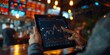 © G.Go - A hand holding a tablet showing live stock exchange data, finger pointing at a specific graph, dynamic stock exchange setting