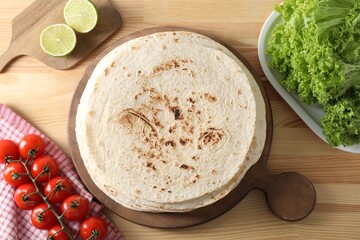 Wall Mural - Many tasty homemade tortillas and products on wooden table, flat lay