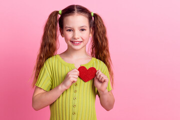 Sticker - Photo portrait of lovely little girl hold heart postcard dressed stylish green garment isolated on pink color background