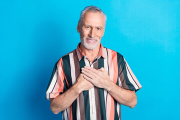 Wall Mural - Photo of handsome kind peaceful senior man wear striped stylish clothes isolated on blue color background