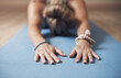 © peopleimages.com - Hands, yoga and close up of woman stretching with workout for energy and wellness. Female yogi, health and flexible at gym for fitness, exercise and relax for muscle, recovery and zen or balance