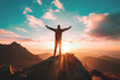 © StockUp - A person stands with arms raised on a mountain peak, backlighted by a stunning sunrise, symbolizing triumph and freedom