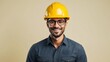 © Pixelpur - A happy male engineer wearing yellow helmet, looking straight into the camera, full body till waist, placed extreme right side, light yellow background
