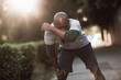 © Geber86 - African American man catching breath after morning run in park