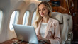 © Alex Alex - confident businesswoman working on laptop in plane during business trip