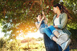 © peopleimages.com - Smile, mother and child on tire swing outdoor for bonding and play fun game together in nature. Happy, mom and push girl in playground at park for love, care and family connection in summer sunshine