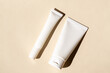 © ADDICTIVE STOCK - Skincare tubes with artistic shadow on neutral background