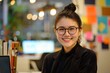 © Odin AI - Young Asian woman with glasses smiling in a modern office filled with colorful sticky notes