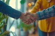 © Odin AI - Close-up of a handshake between two people, surrounded by green plants and warm ambient lighting