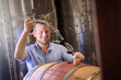 © peopleimages.com - Man, happy and wine maker with glass as manager for tasting, process and production. Supplier, winery and smile in confidence with product for alcohol manufacturing, craft and liquor at factory