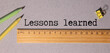 © Uladzislau - blank card with text Lessons learned on wooden background.