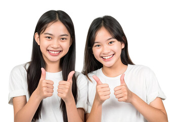 Two cheerful Asian girls wearing white t-shirts and doing thumbs ups at camera posing over isolated transparent background