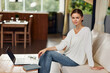 © SHOTPRIME STUDIO - Smiling Woman Enjoying Weekend at Home Laptop Online Shopping in Modern Living Room