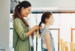 © peopleimages.com - Happy family, woman and daughter in hair care with bonding, affection and trust in home for memory as preteen. Cheerful mom, girl and cute for love, support and childhood development on mothers day