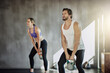 © peopleimages.com - People, kettlebell and fitness training at gym, weightlifting and equipment for power workout. Man, woman and coach for athletes in health club, teamwork challenge and friends support for exercise