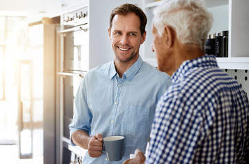 Wall Mural - Happy, man and senior father in kitchen with conversation in morning with coffee for bonding in retirement. Tea, discussion and dad in law on weekend for proposal to daughter with permission in Spain