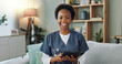© peopleimages.com - Portrait, physiotherapist and nurse with tablet, smile and happiness of black woman for job and career. House, female person and employee online with internet for information of medicine of patient