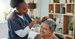 © peopleimages.com - Living room, elderly man and nurse with comb for hair care, grooming or support in nursing home. Senior person, medical professional and discussion with helping for wellness, hairstyle and retirement